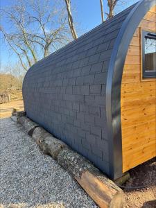 a rendering of a building with a wall at Springfield oaks Glamping Pod in Isle of Wight