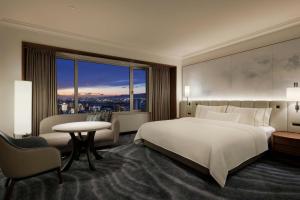 a bedroom with a large white bed and a window at The Westin Osaka in Osaka