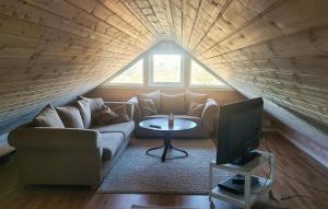 a living room with a couch and a tv at 1 Bedroom Amazing Apartment In Stord in Stord