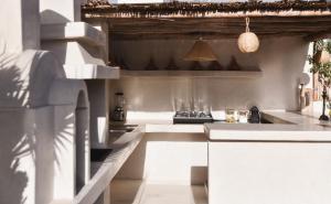 a kitchen with white counters and a stove top oven at Riad Soulmate in Marrakesh