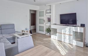 a living room with a flat screen tv on a wall at Stunning Apartment In Swinoujscie in Świnoujście