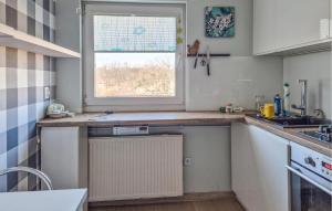 a kitchen with a sink and a window at Stunning Apartment In Swinoujscie in Świnoujście