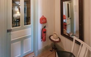 a room with a door with a fire extinguisher on the wall at Lovely Apartment In Åseda With Wifi in Åseda