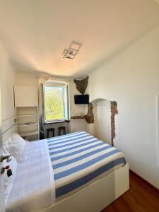 A bed or beds in a room at Belvedere Affittacamere