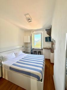 A bed or beds in a room at Belvedere Affittacamere