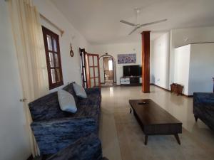 a living room with a couch and a coffee table at J and R Villa, Watamu in Watamu