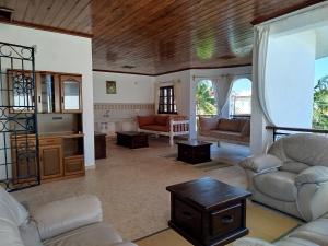 a large living room with couches and a table at J and R Villa, Watamu in Watamu