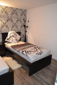 a bed sitting in a room with a wooden floor at Loft Apartment Horrem in Kerpen