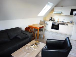 a living room with a couch and a table at Apartments Bensersiel in Esens