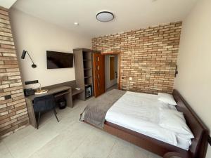 Voodi või voodid majutusasutuse Komilfo Hotel toas