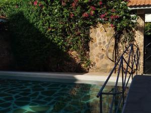 a chair sitting next to a swimming pool with flowers at J and R Villa, Watamu in Watamu