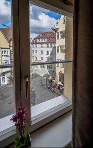 a window with a view of a building at Ruben's Apartments in Stuttgart