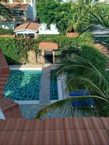 an overhead view of a swimming pool with a palm tree at J and R Villa, Watamu in Watamu