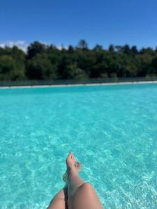 a person laying in the water with their toes in the water at BUENA VIDA I Apart Hotel in Villa Icho Cruz