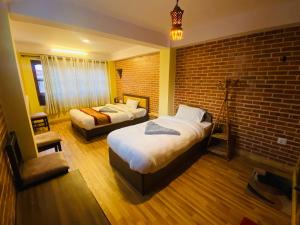 Postel nebo postele na pokoji v ubytování Hotel Durbar Side