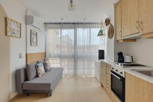 a kitchen with a couch in a small kitchen at Horizonte beachfront apartment in Ifach