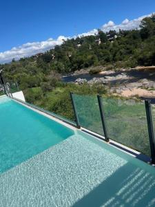 a swimming pool with a view of the ocean at BUENA VIDA I Apart Hotel in Villa Icho Cruz