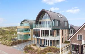 an architectural rendering of a large building with glass at Sea Bass in Egmond aan Zee +28 photos