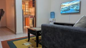 a living room with a couch and a table at Angie's Nest in Syokimau