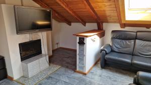 a living room with a couch and a television and a chair at Wohnung im Landhausstil für Monteure in Budenheim in Budenheim