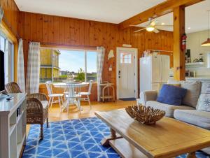 a living room with a couch and a table at Spinneys Guesthouse & Beach Cottages in Phippsburg