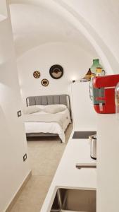 a bedroom with a bed in a white room at B&B La Casa Di Bianca in Manfredonia
