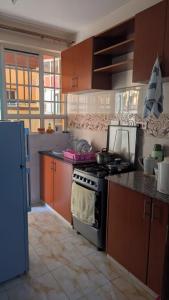 a kitchen with a stove and a counter top at Angie's Nest in Syokimau