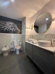 a bathroom with a sink and a toilet and a mirror at Port Saplaya 3 Valencia in Port Saplaya +18 photos