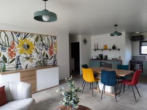 a kitchen and living room with a table and chairs at Détente à Portbail in Portbail