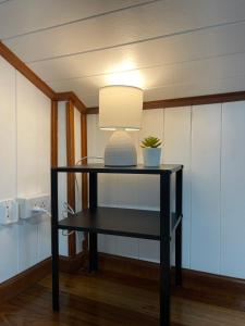 a black table with a lamp on top of it at Anna River Home A3 in Ban Khlong Si +31 photos