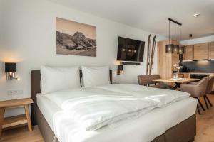 Voodi või voodid majutusasutuse AlpenParks Hotel & Apartment Taxacher toas