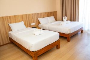 Een bed of bedden in een kamer bij Hotel Quest