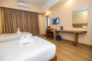 Een bed of bedden in een kamer bij Hotel Quest
