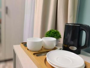 a coffee pot and two cups on a wooden tray at Hayq Hotel in Yerevan +17 photos