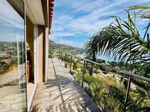 a balcony of a house with a view of the ocean at Saint Clair, la plage à pied in Le Lavandou