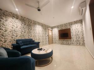 a living room with a couch and a table at VV's Lakshmi Inn in Thekkumkara