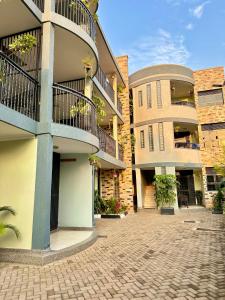 a group of buildings with balconies and a brick courtyard at Supreme Apartments in Kansiri