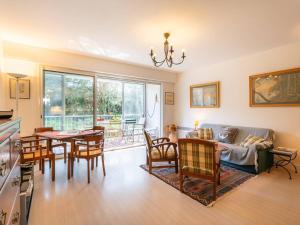 a living room with a couch and a table and chairs at Appartement 3 pièces + studio, 90m² pour 5 pers., La Trinité-sur-Mer - FR-1-477-255 in La Trinité-sur-Mer