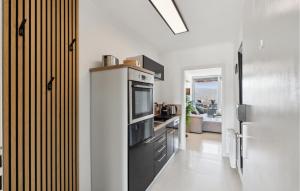 a kitchen with a stove and a refrigerator at Cozy Apartment In Bad Harzburg in Bad Harzburg