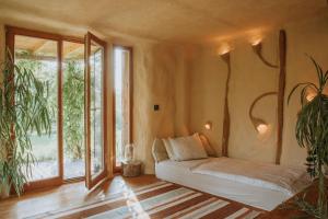 a living room with a couch and a large window at Private Eco Cottage in Nature in Šulinci