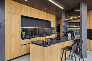 a kitchen with a black counter and wooden walls at Coalhouse Pfalz in Sankt Martin