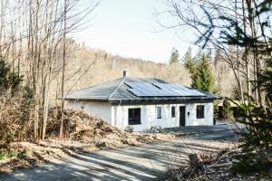 a small white house on the side of a road at NEU Inner Light, mit privater Sauna und schnellen Internet, Luxuriöses Ferienhaus im Harz in Altenau