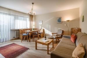 a living room with a couch and a table at Ferienwohnanlage Oberaudorf C 2 mit Hallenbad und Sauna in Oberaudorf