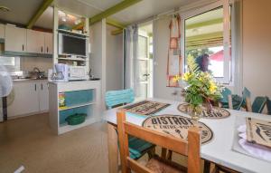 a kitchen with a table and chairs in a tiny house at Gorgeous Stacaravan In Casalabriva in Casalabriva