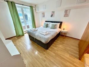 a bedroom with a bed and a large window at City Centre Apartment, Nr West Quay, Free Parking in Southampton