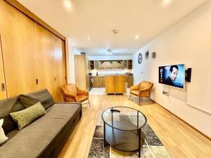 a living room with a couch and chairs and a tv at City Centre Apartment, Nr West Quay, Free Parking in Southampton