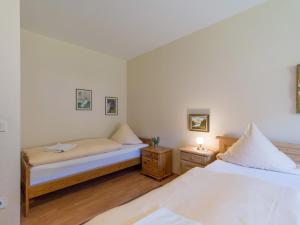a bedroom with two beds and two night stands at Ferienwohnanlage Oberaudorf D 2 mit Hallenbad und Sauna in Oberaudorf +16 photos