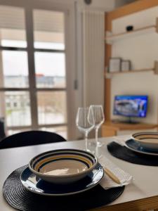 a table with two plates and a glass of wine at Boutique Home in Castelfranco Veneto