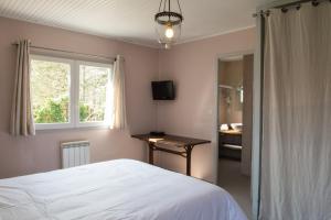 Postel nebo postele na pokoji v ubytování Maison de Mézos