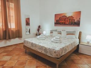 a bedroom with a large bed with pillows on it at Sicania - In centro Storico a Palermo in Palermo +57 photos